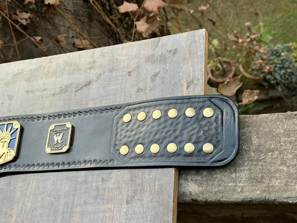 WWE United States Championship replica belt, strap plate and snap studs close-up