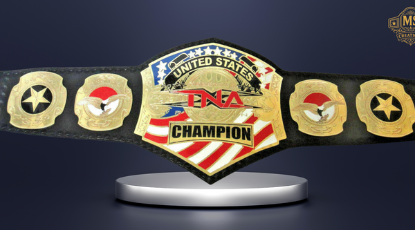 A high-quality studio shot of the tna united states championship belt, prominently displayed on a silver stand against a dark background.