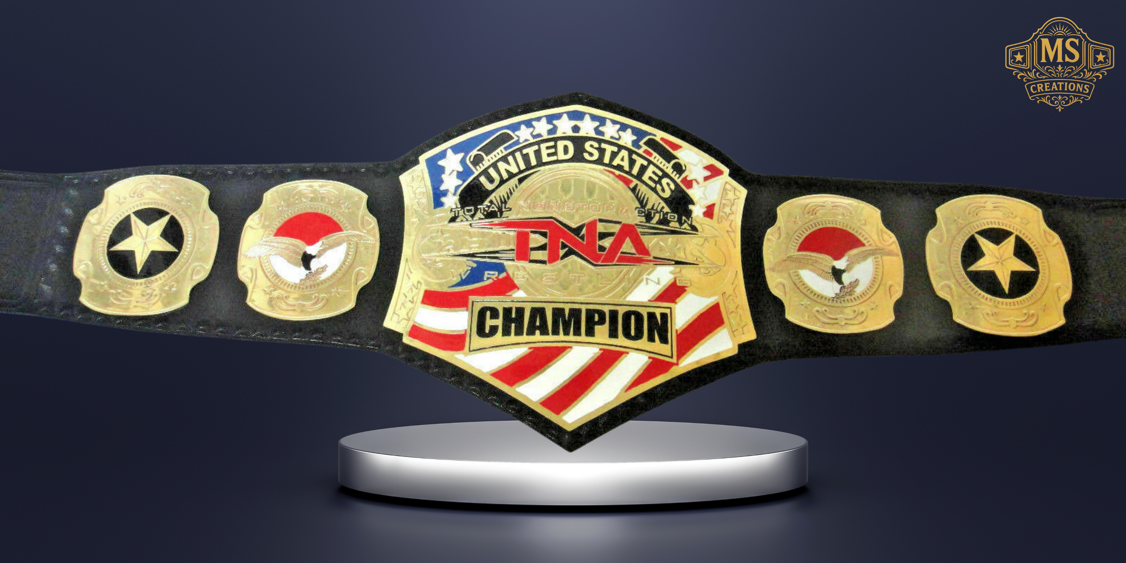 A high-quality studio shot of the tna united states championship belt, prominently displayed on a silver stand against a dark background.